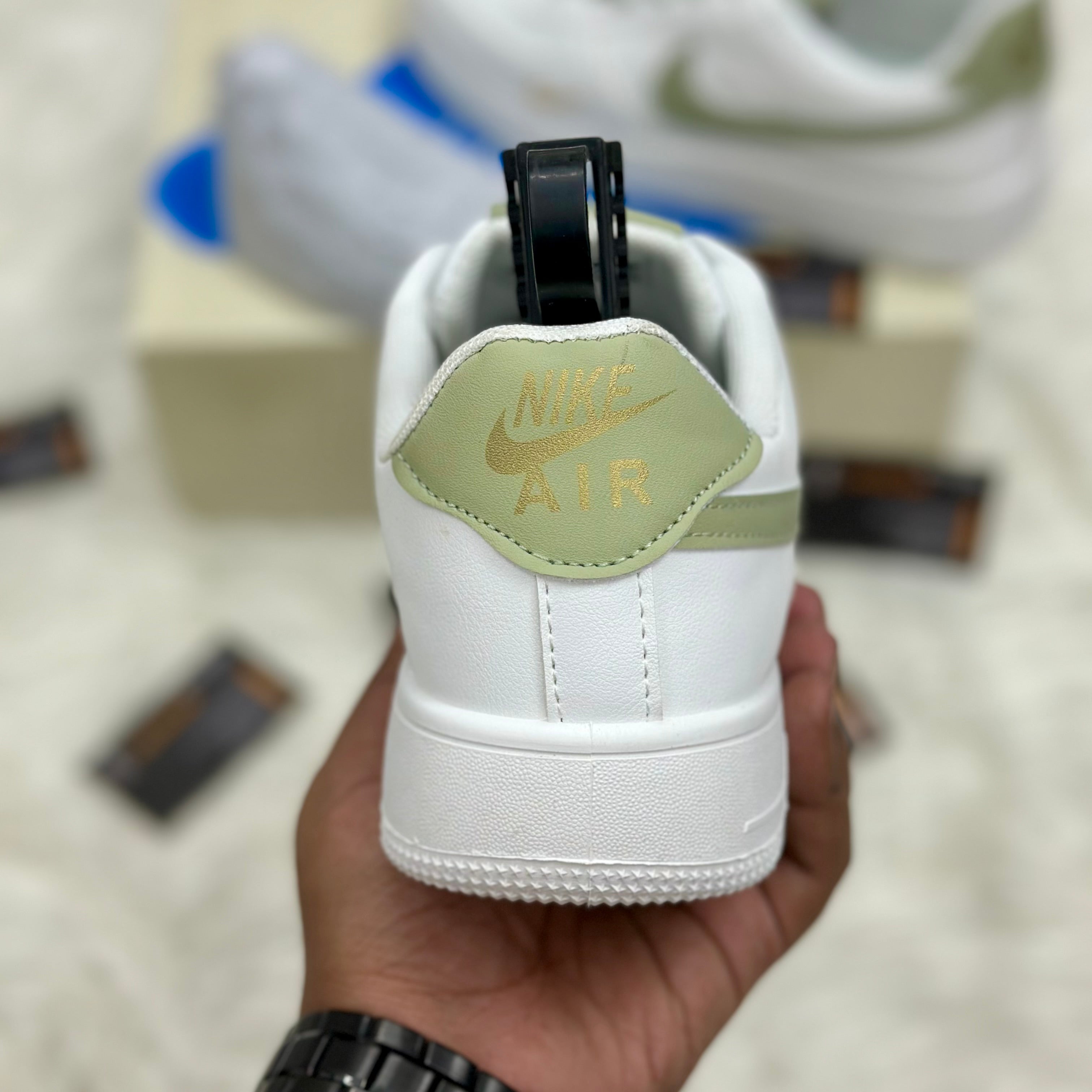 Nike Air Force 1 ’07 LV8 “Mini Swoosh” — White/Light Olive/Metallic Gold.